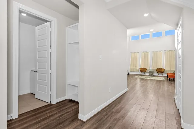 a view of a hallway view with wooden floor and furniture