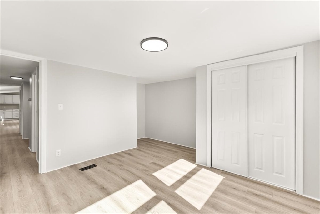 5 Marks Way Carver, MA 02330 - Photo 22 of 23 an empty room with wooden floor and windows