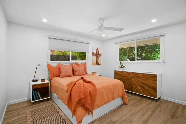 a bed room with a bed and a large window