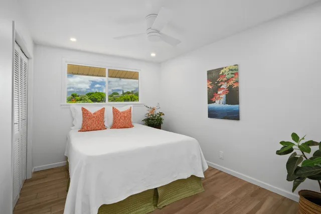 a bedroom with a bed and a painting on the wall