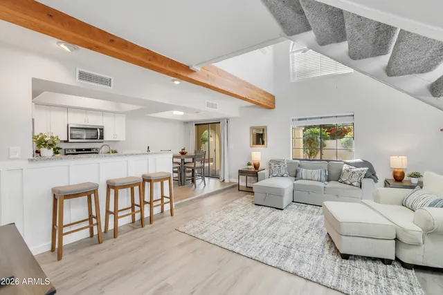 a living room with furniture and kitchen view