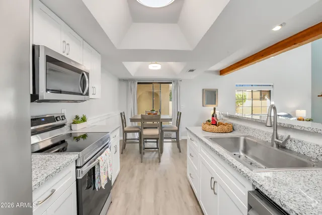 a kitchen that has a sink and wooden cabinets