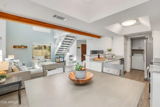 a living room with furniture and a kitchen