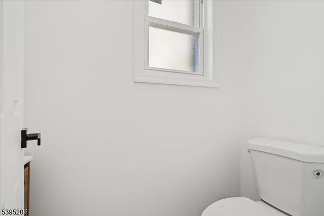 a white toilet sitting next to a bathroom sink