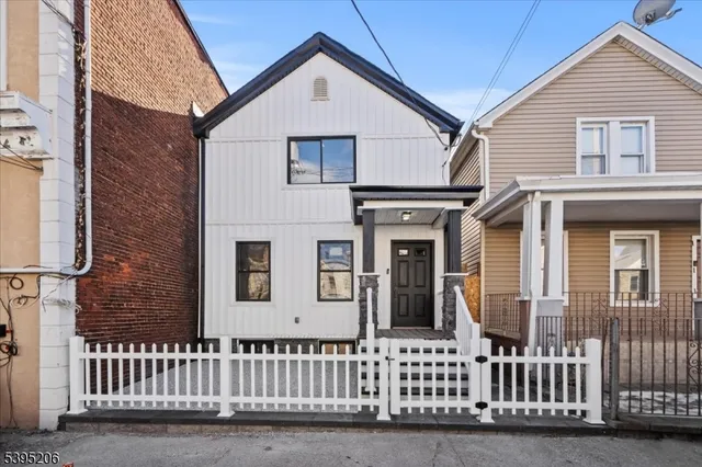 a view of a brick house with large windows