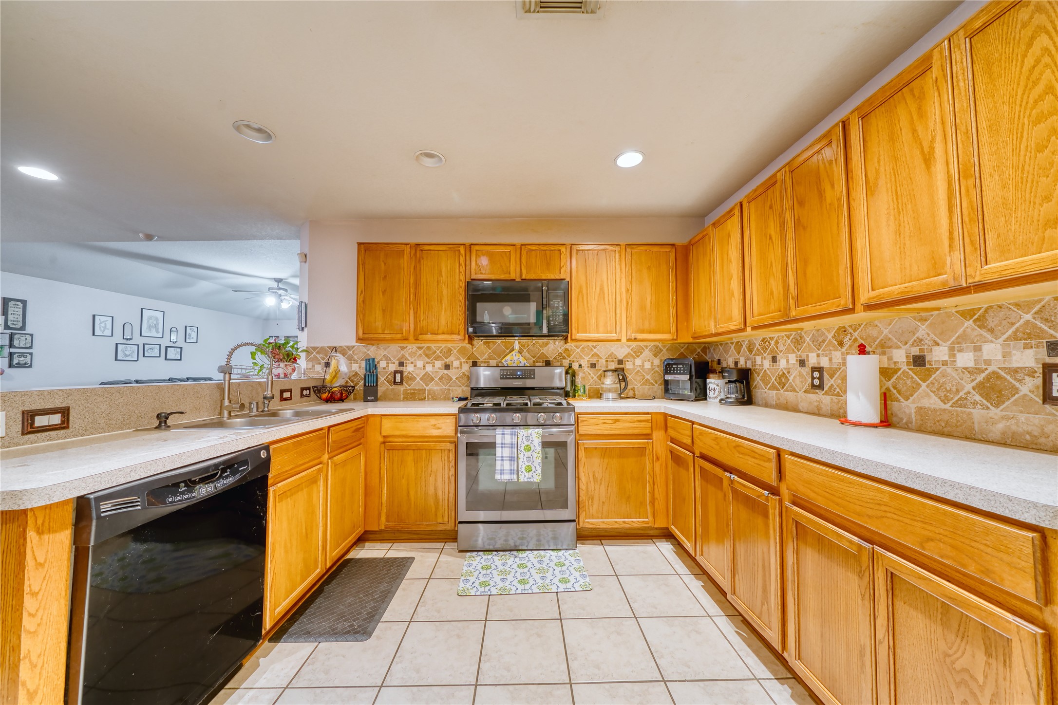 2210 Mountain Ranch Drive Houston, TX 77049 - Photo 31 of 36 a kitchen with stainless steel appliances granite countertop a sink and cabinets