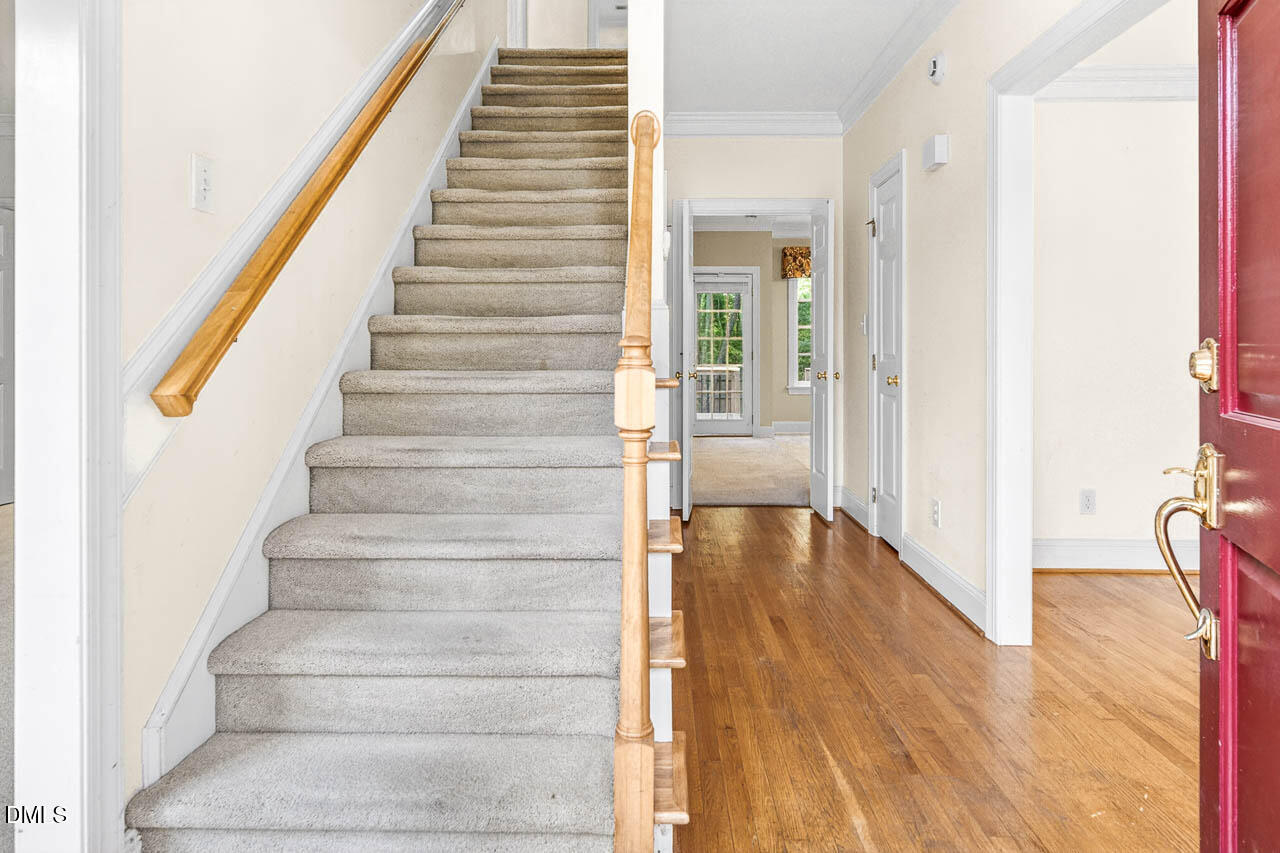 2209 Lodestar Drive Raleigh, NC 27615 - Photo 26 of 50 a view of an entryway with wooden floor and door