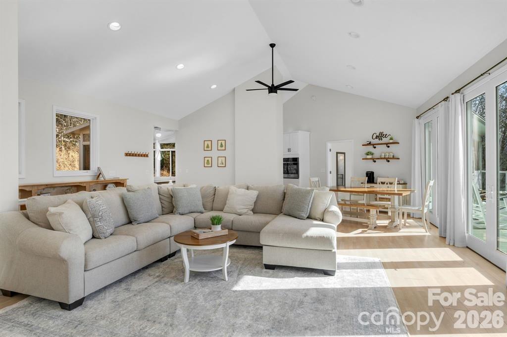 56 Great Horned Owl Road Candler, NC 28715 - Photo 6 of 32 a living room with furniture and a chandelier