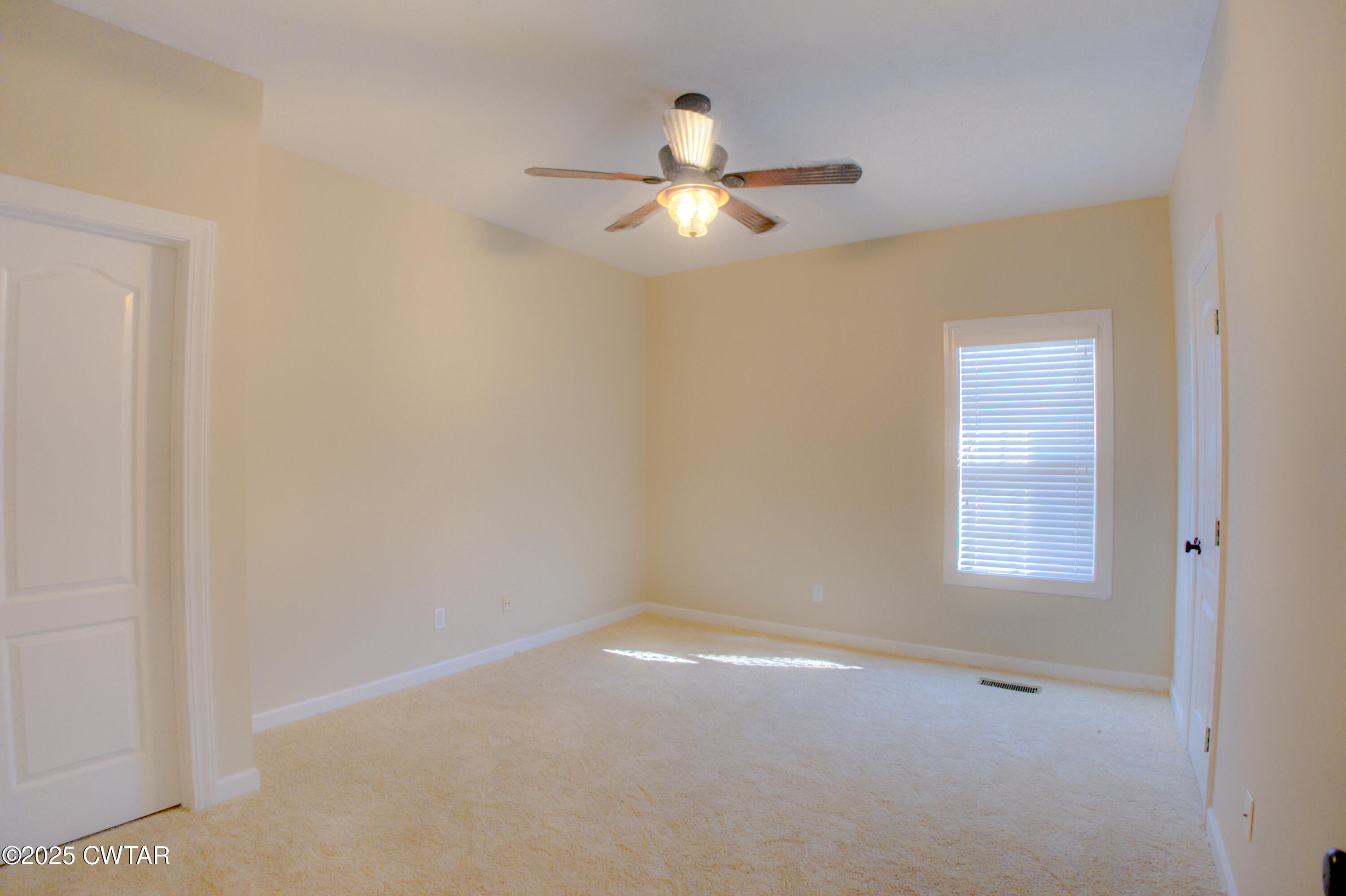 135 Fox Run Cove Henderson, TN 38340 - Photo 17 of 21 an empty room with a window and a fan