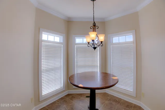 a view of a livingroom with a table and chairs