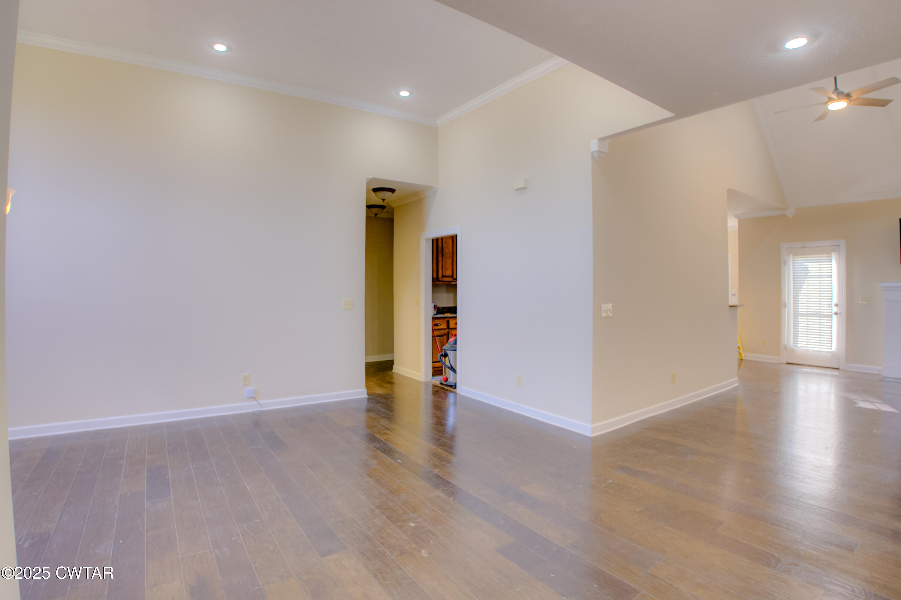 135 Fox Run Cove Henderson, TN 38340 - Photo 8 of 21 a view of an empty room with wooden floor and a window