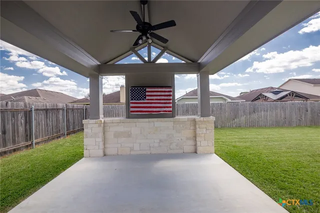 a view of a backyard with wooden fence