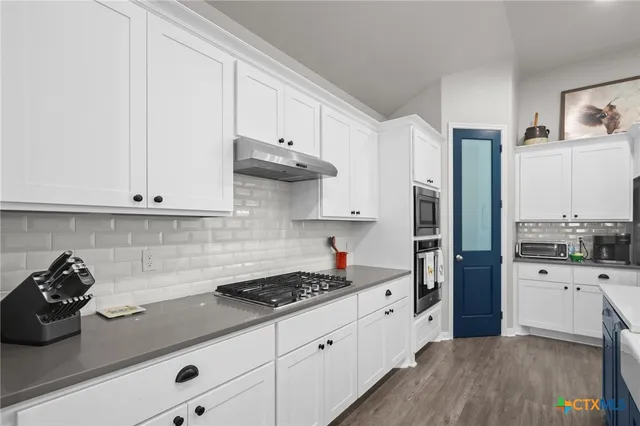 a kitchen with stainless steel appliances cabinets and a counter top space