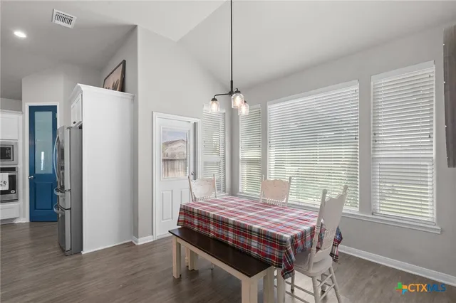 a living room with a bed and a window