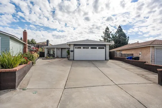a front view of house with yard and car parked
