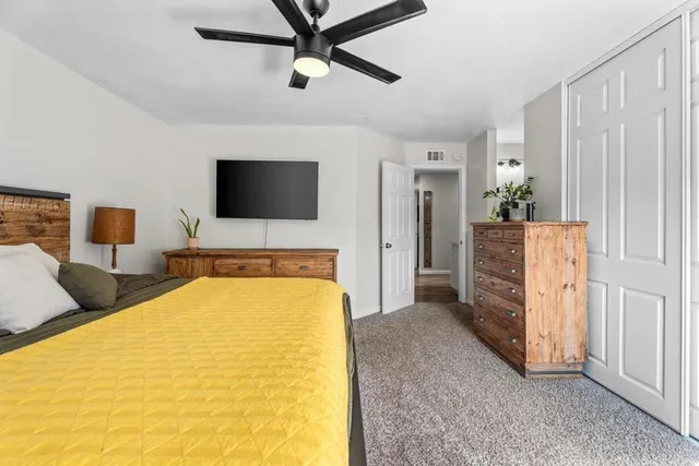 a bedroom with a bed and a dresser