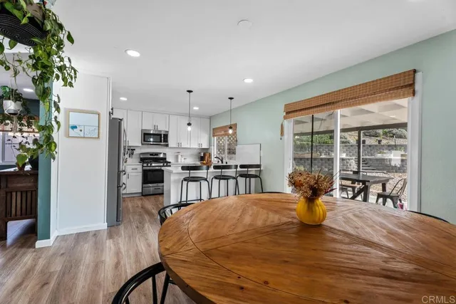 a view of a dining room with furniture and a potted plant