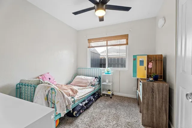 a bedroom with furniture and a flat screen tv