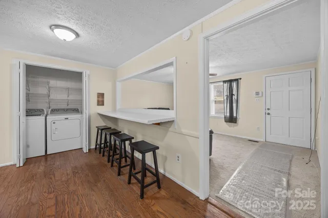 a view of a room with wooden floor sink and windows