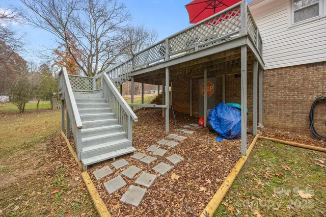 a backyard of a house with table and chairs