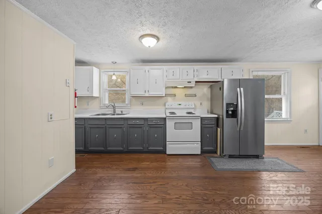 a kitchen with stainless steel appliances a refrigerator and a stove top oven