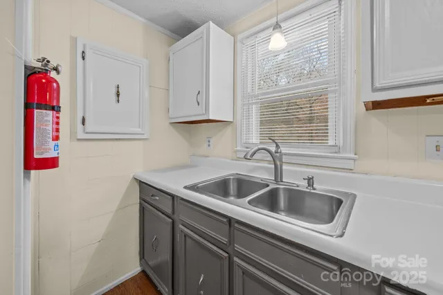 a kitchen with sink a refrigerator and cabinets
