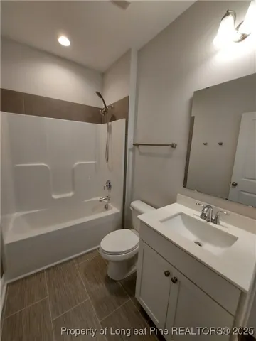 a bathroom with a sink toilet a mirror and shower