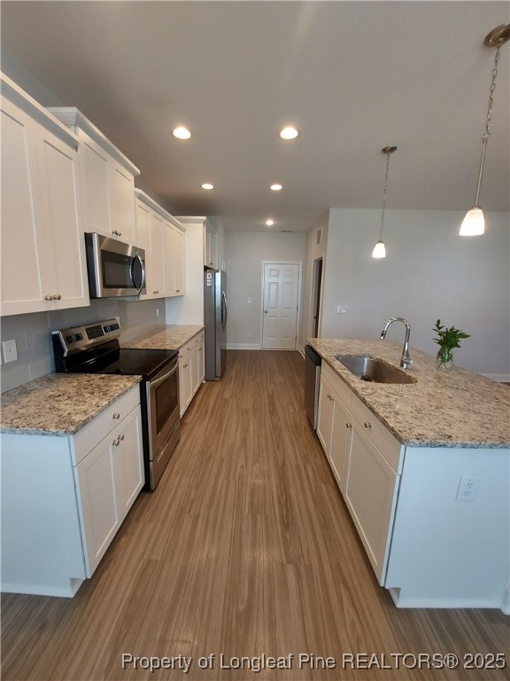1641 Stackhouse Drive Fayetteville, NC 28314 - Photo 26 of 31 a large kitchen with stainless steel appliances kitchen island granite countertop a large stove a sink dishwasher and a microwave with wooden floor