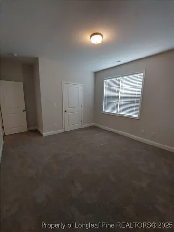 an empty room with a empty space and windows