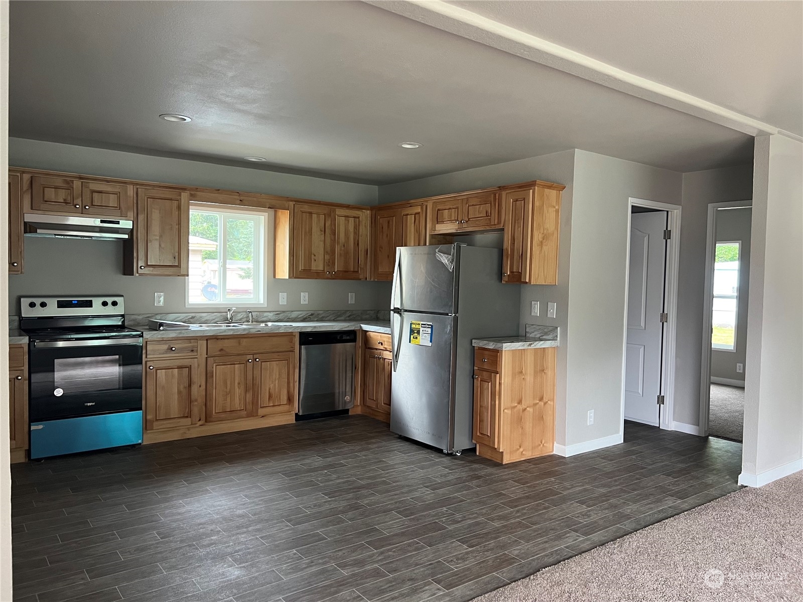 2610 Calawah Way, Unit 44 Forks, WA 98331 - Photo 3 of 12 a kitchen with a refrigerator and a stove top oven