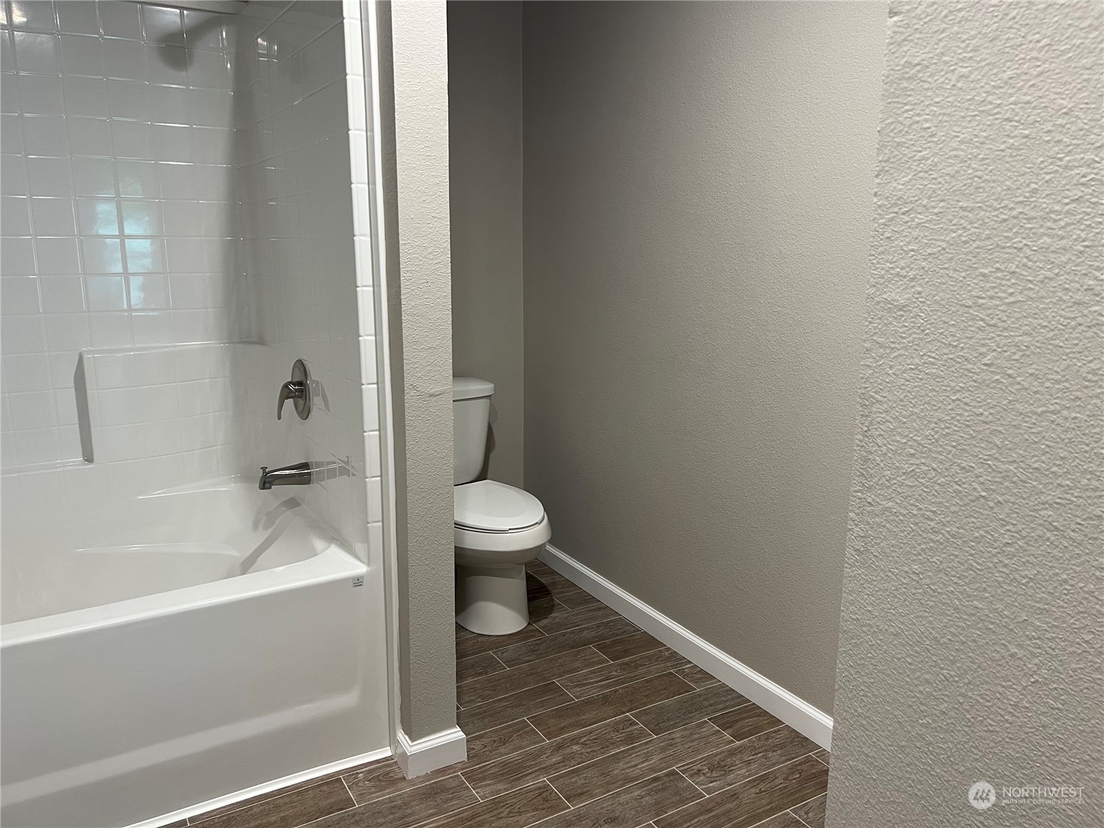 2610 Calawah Way, Unit 44 Forks, WA 98331 - Photo 7 of 12 a bathroom with a bathtub and toilet