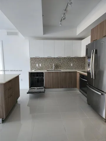 a kitchen with stainless steel appliances a stove and a refrigerator