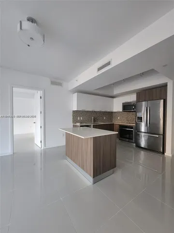 a kitchen with a refrigerator and a sink
