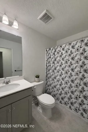 a bathroom with a toilet a sink and a mirror
