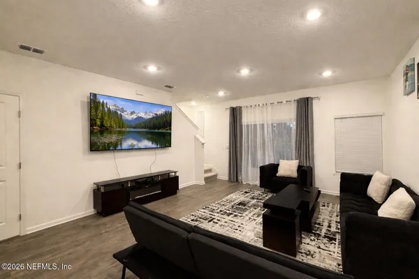 a living room with furniture and a flat screen tv