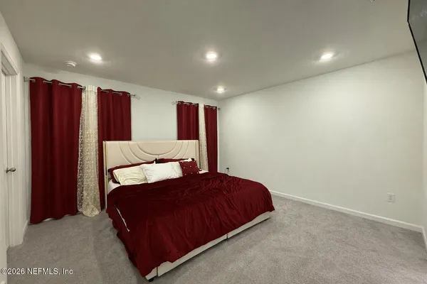 a bedroom with a bed and a walk in closet