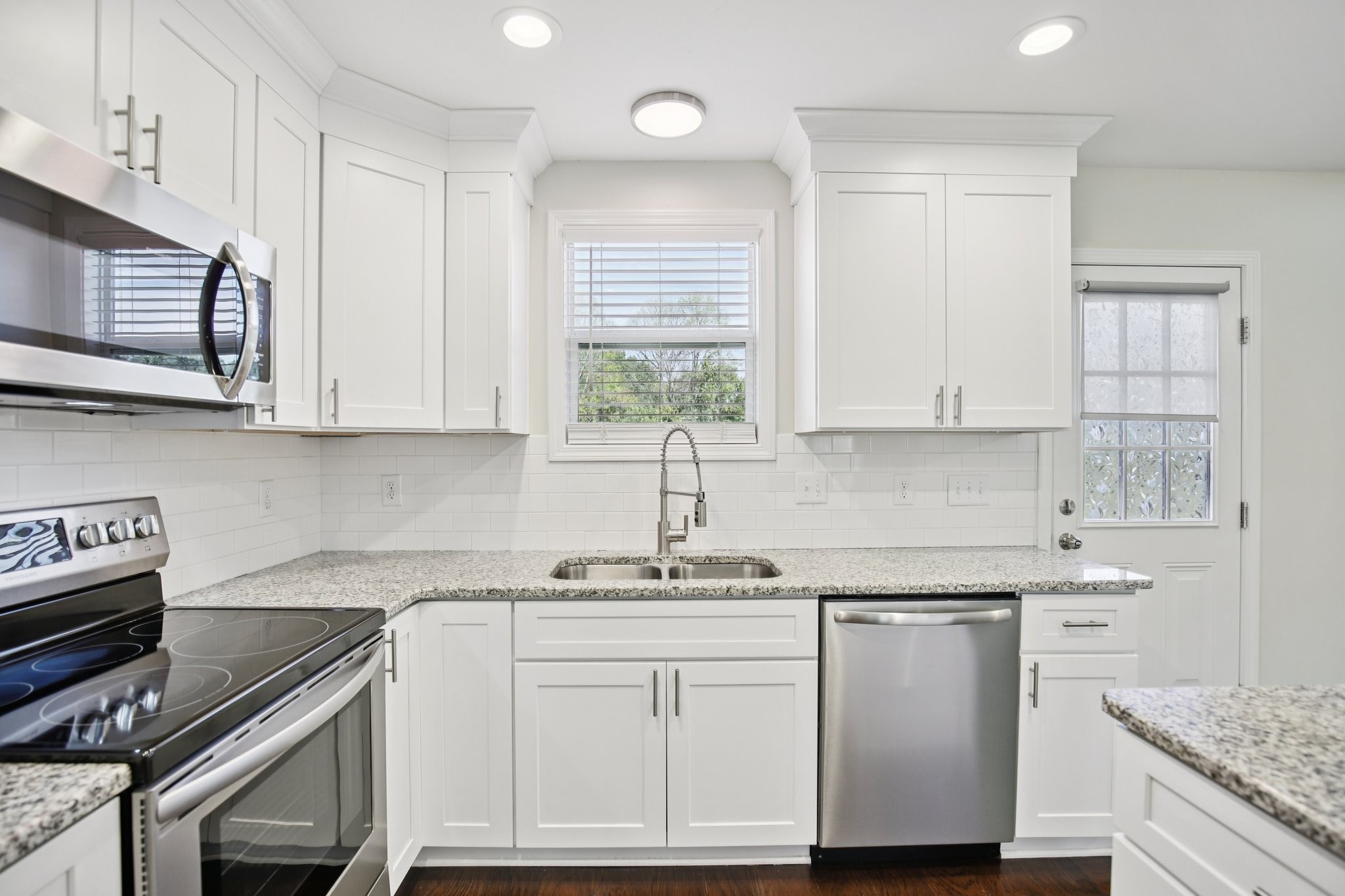 135 Ray Jent Road Bethpage, TN 37022 - Photo 5 of 17 a kitchen with white cabinets and white appliances