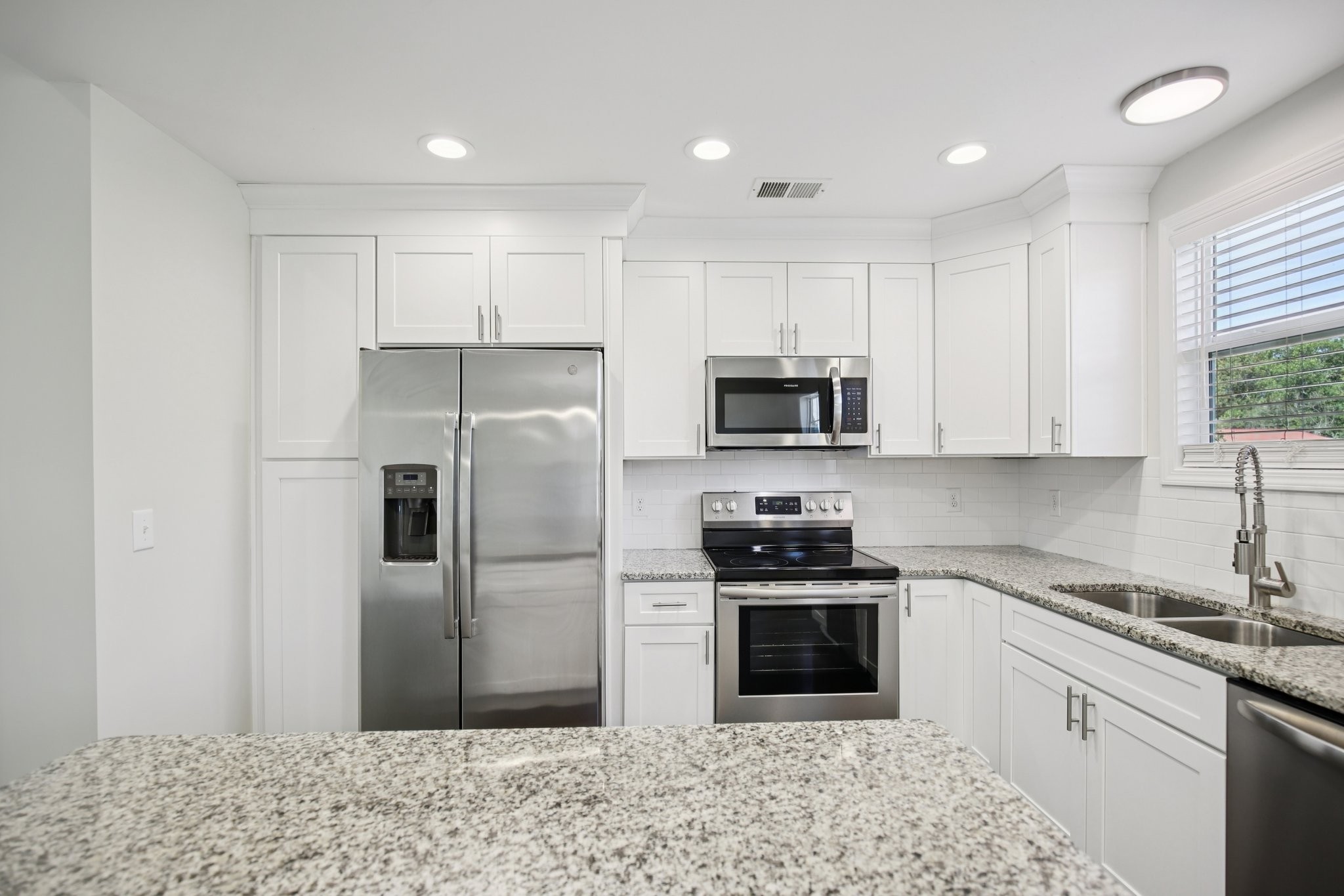 135 Ray Jent Road Bethpage, TN 37022 - Photo 6 of 17 a kitchen with stainless steel appliances granite countertop a refrigerator sink and stove