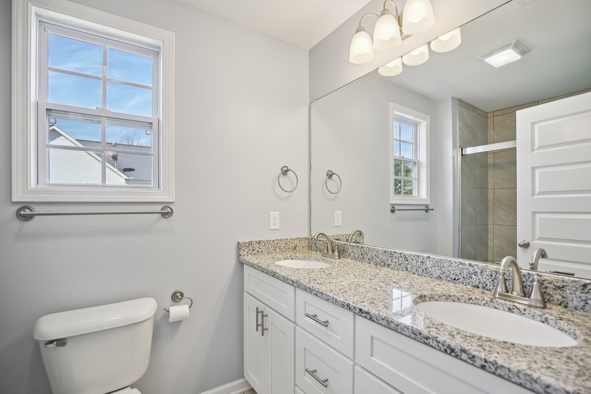 135 Ray Jent Road Bethpage, TN 37022 - Photo 9 of 17 a bathroom with a granite countertop sink a toilet and a mirror