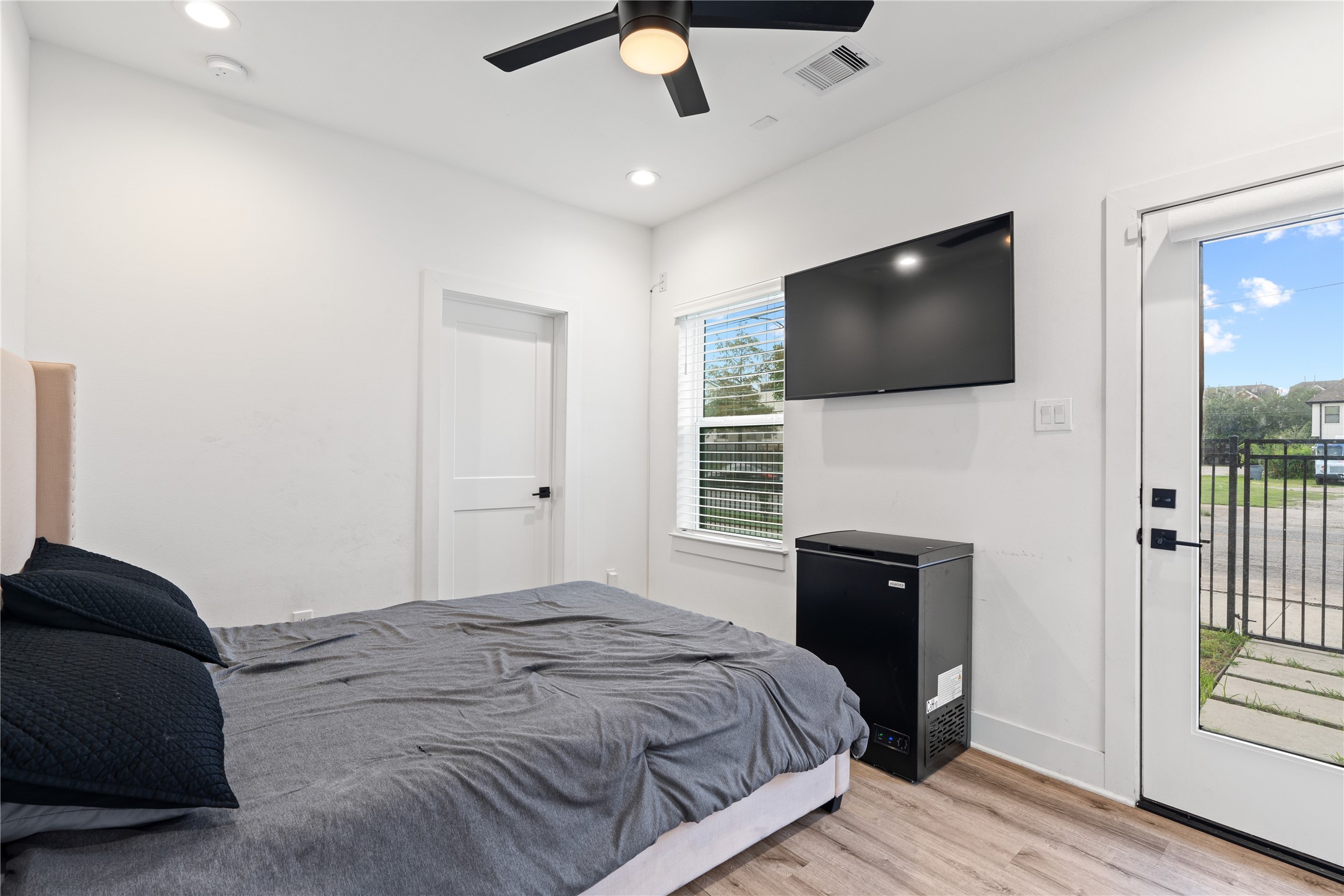 2404 Hadley Street, Unit C Houston, TX 77004 - Photo 13 of 16 a bedroom with a bed and a flat screen tv