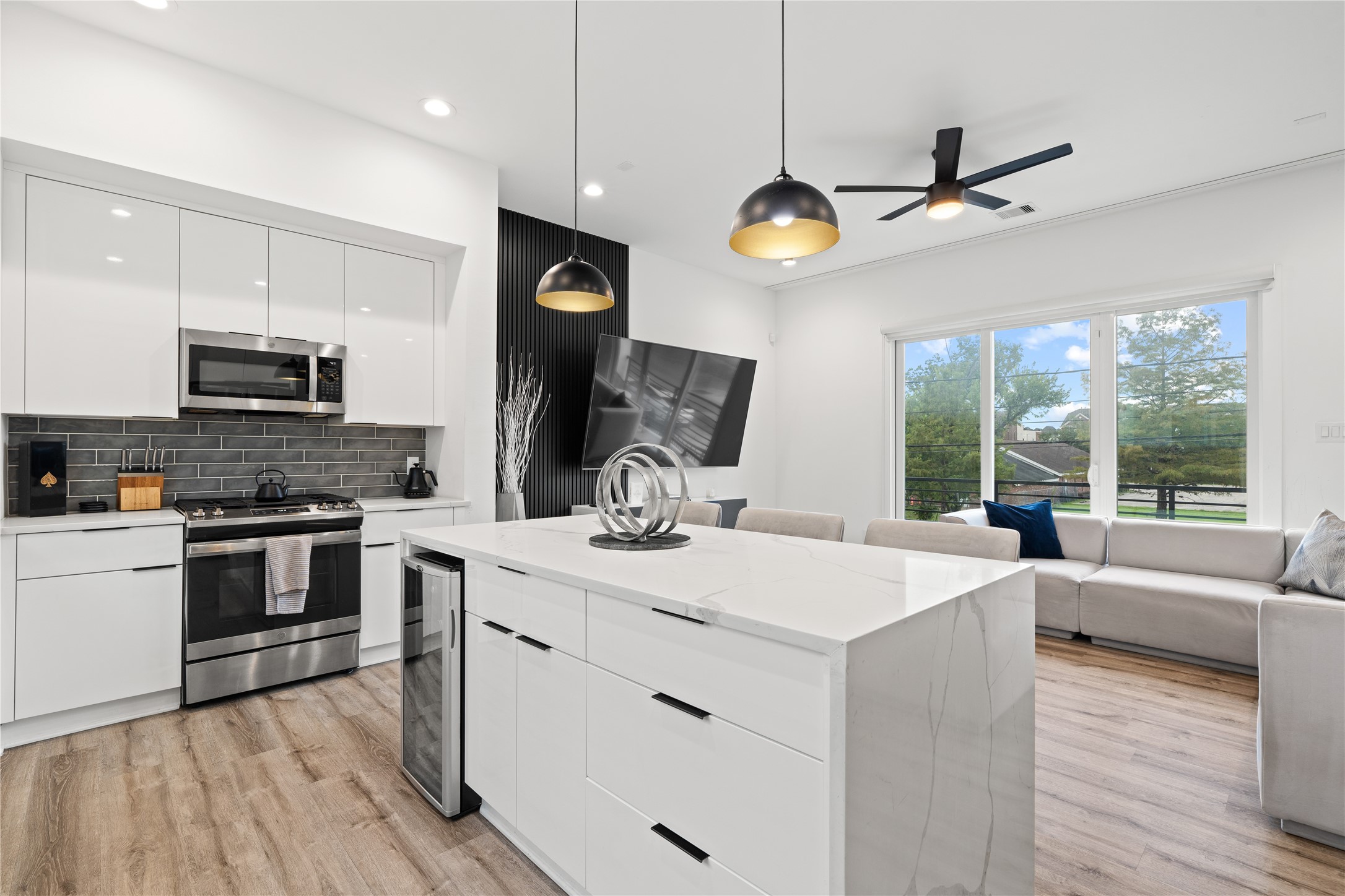 2404 Hadley Street, Unit C Houston, TX 77004 - Photo 2 of 16 a kitchen with kitchen island granite countertop a sink cabinets and stainless steel appliances