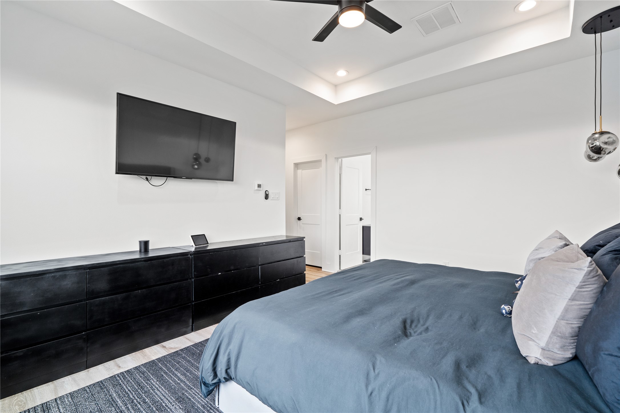 2404 Hadley Street, Unit C Houston, TX 77004 - Photo 3 of 16 a bedroom with a bed and a flat screen tv