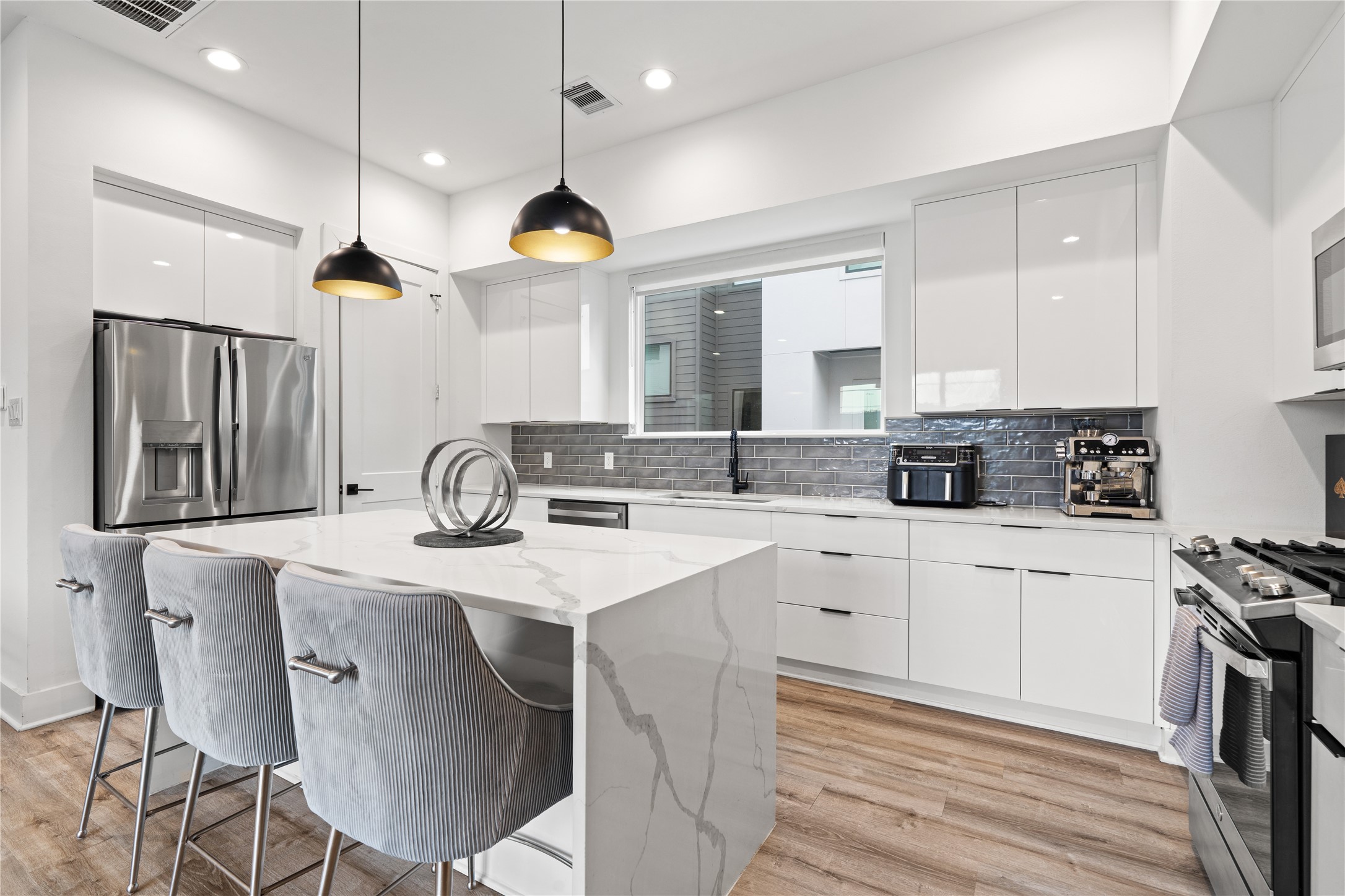 2404 Hadley Street, Unit C Houston, TX 77004 - Photo 4 of 16 a kitchen with a sink cabinets and window