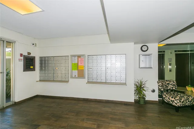a large white room with stainless steel appliances wooden floors and white walls