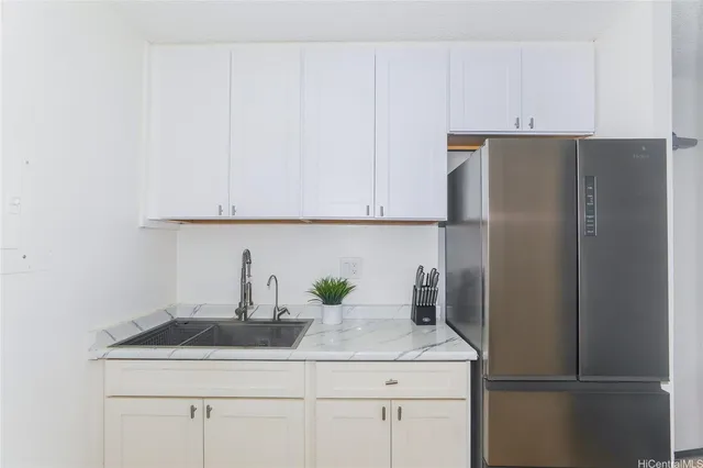 a kitchen with a refrigerator and cabinets
