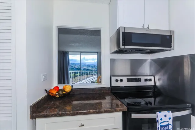 a kitchen with a stove and a microwave