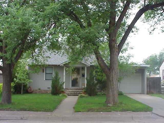 4604 Parker Street Amarillo, TX 79110 - Photo 1 of 1 a front view of a house with a garden