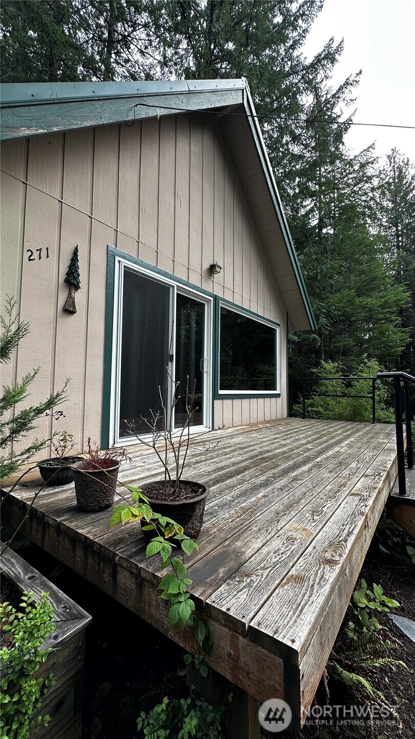 271 Salmon Street Brinnon, WA 98320 - Photo 2 of 17 a view of house with backyard and seating space