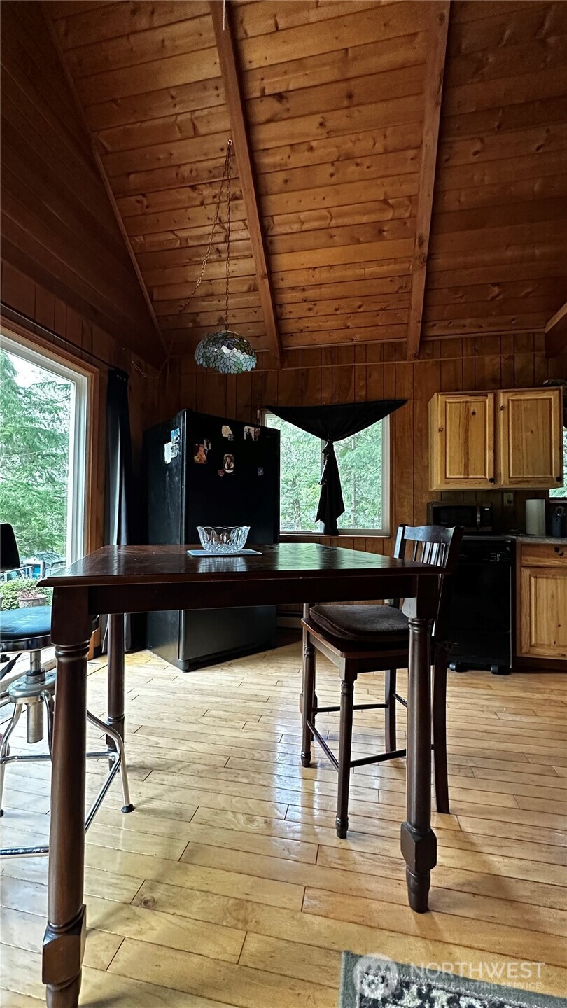 271 Salmon Street Brinnon, WA 98320 - Photo 6 of 17 a view of a patio with a table chairs and wooden floor