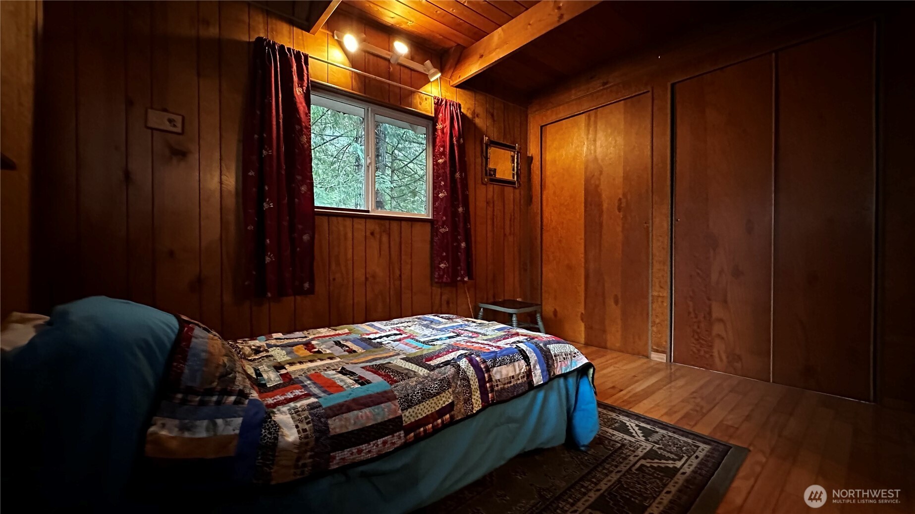 271 Salmon Street Brinnon, WA 98320 - Photo 10 of 17 a bedroom with a bed and a window